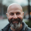 Image of a bald man with a beard smiling